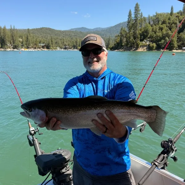 Guest showing off a large rainbow trout caught on Bass Lake